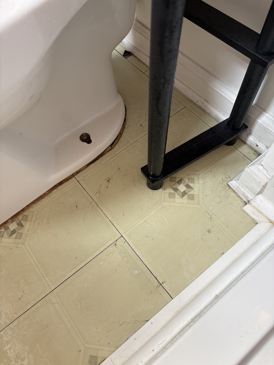 Before bathroom floor perimeter detail cleaning